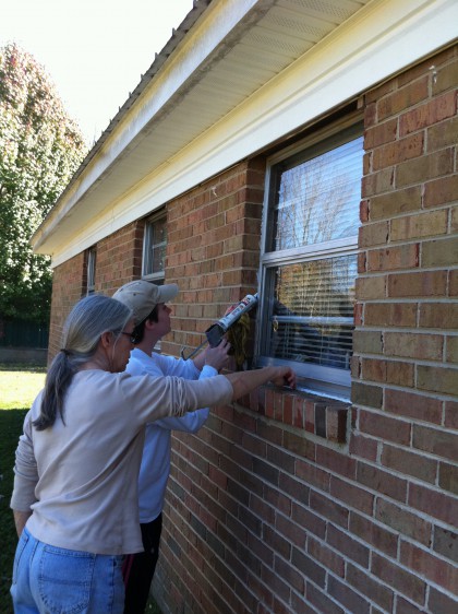 UUCH Team Social Justice helping CASA TEMPS winterize a home for an elderly woman of minimal means.